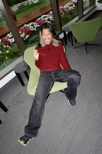 a man sitting on a green chair